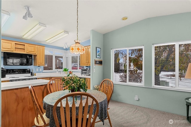 kitchen featuring pendant lighting, light carpet, lofted ceiling, and white range with electric stovetop