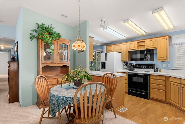 kitchen featuring light brown cabinetry, decorative light fixtures, white fridge with ice dispenser, electric stove, and light hardwood / wood-style floors