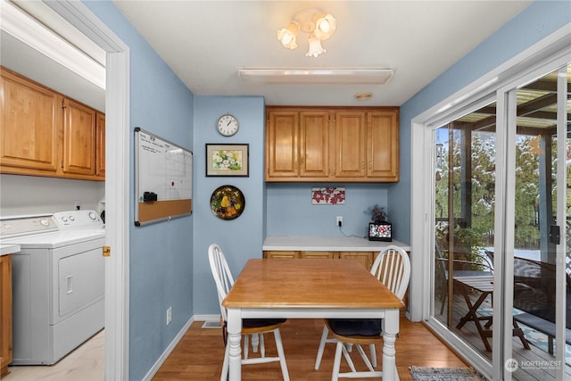 dining space with separate washer and dryer and light wood-type flooring