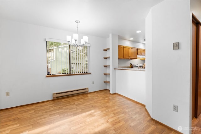 unfurnished dining area featuring a notable chandelier, baseboard heating, and light hardwood / wood-style flooring