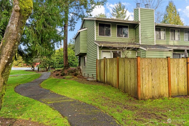 view of property exterior featuring a lawn