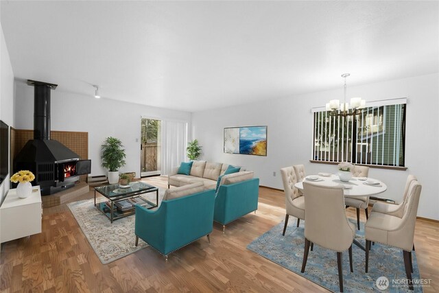 13231 SE 256th St Unit K4, Kent, WA 98042 - living room featuring a chandelier, wood finished floors, and a wood stove