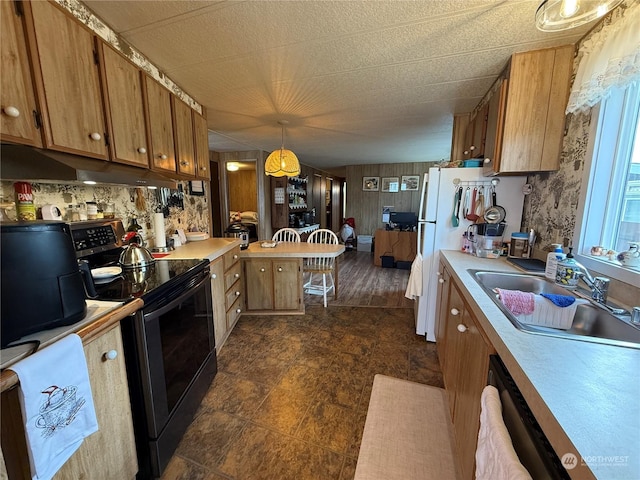 kitchen with sink, stainless steel dishwasher, black / electric stove, decorative light fixtures, and white fridge