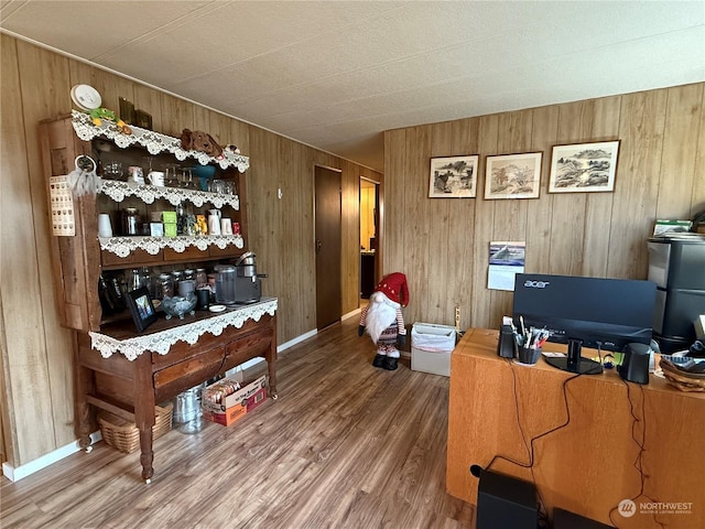 home office with wood walls and hardwood / wood-style floors