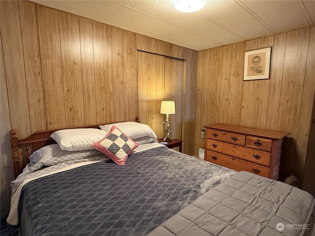 bedroom featuring wood walls