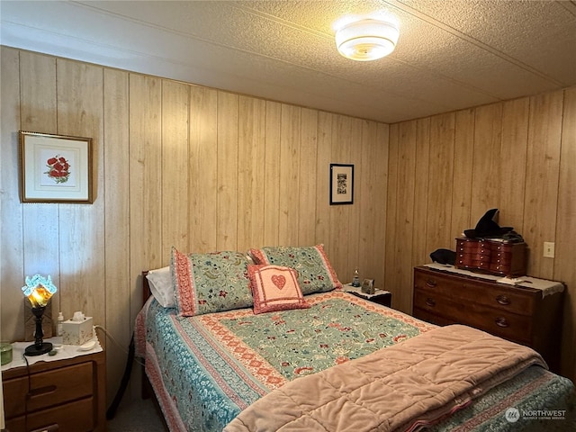 bedroom featuring wooden walls