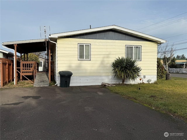 view of side of home featuring a yard