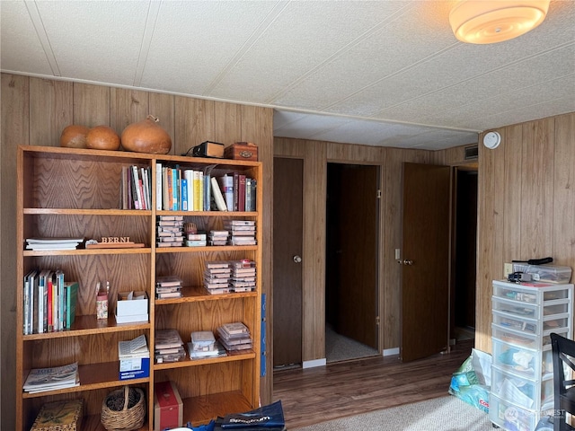 interior space featuring hardwood / wood-style flooring and wooden walls