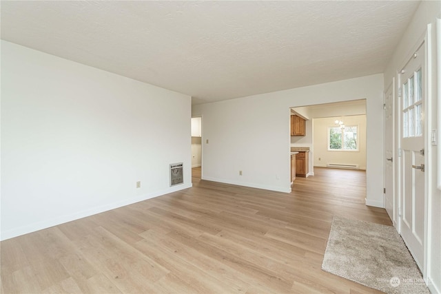 unfurnished living room featuring a textured ceiling, a baseboard radiator, light hardwood / wood-style flooring, and heating unit