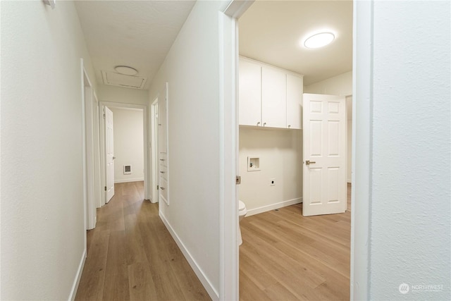 hallway with light hardwood / wood-style floors