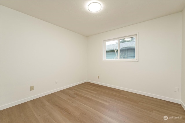 empty room with hardwood / wood-style floors