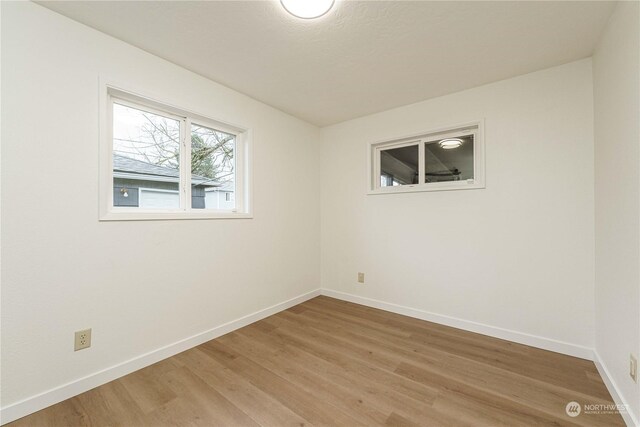 empty room featuring wood-type flooring