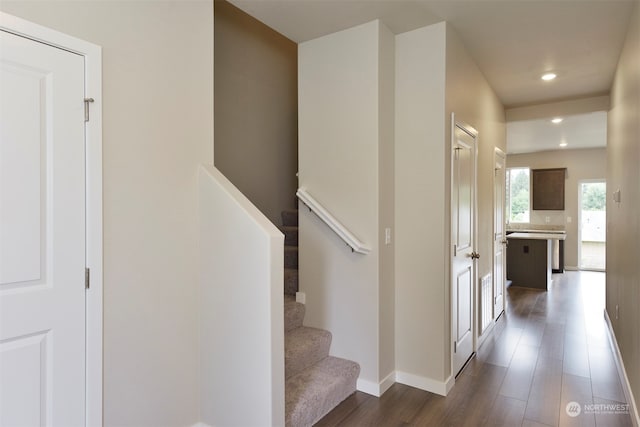 stairs featuring hardwood / wood-style flooring