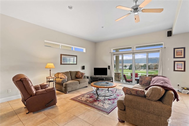 living room featuring ceiling fan and light tile patterned flooring