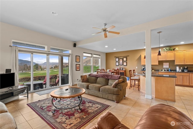 living room featuring ceiling fan and light tile patterned floors