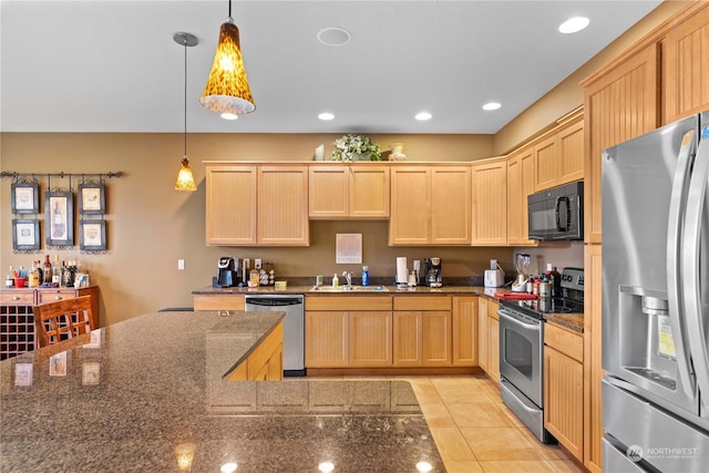 kitchen featuring light brown cabinetry, pendant lighting, stainless steel appliances, and sink