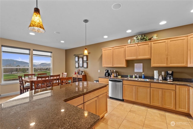 kitchen featuring a mountain view, sink, pendant lighting, dark stone countertops, and dishwasher