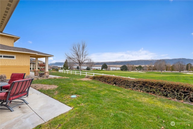 view of yard featuring a mountain view and a patio area