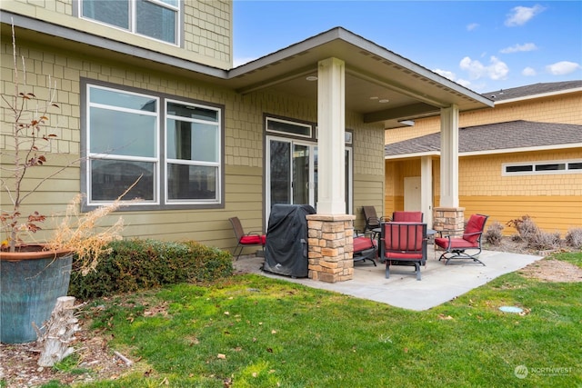 rear view of property with a lawn and a patio