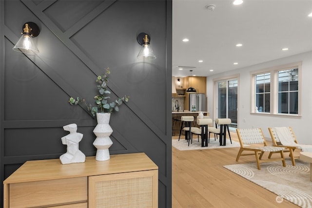 interior space with hardwood / wood-style flooring, sink, and stainless steel refrigerator