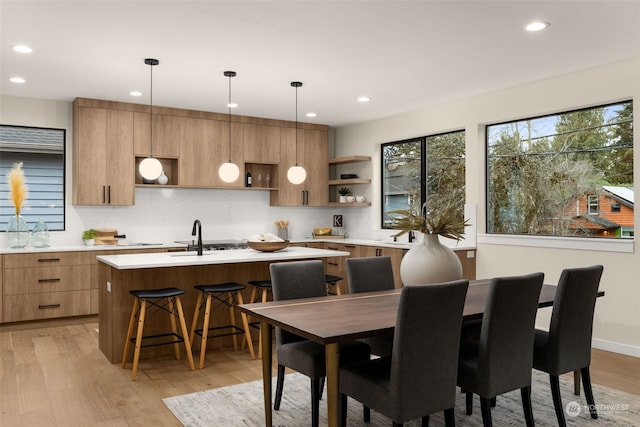 dining room with light wood-type flooring and sink