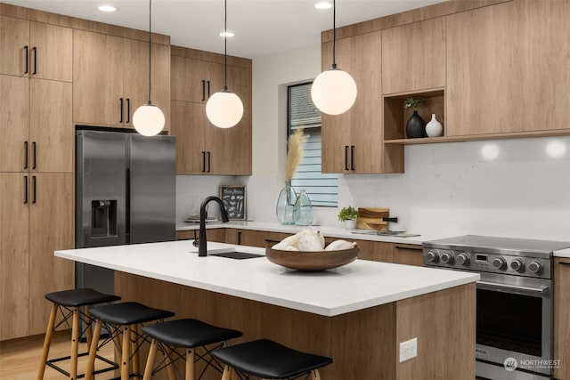 kitchen with a kitchen bar, stainless steel appliances, hanging light fixtures, and sink