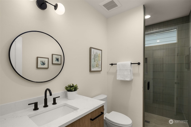 bathroom with walk in shower, vanity, and toilet