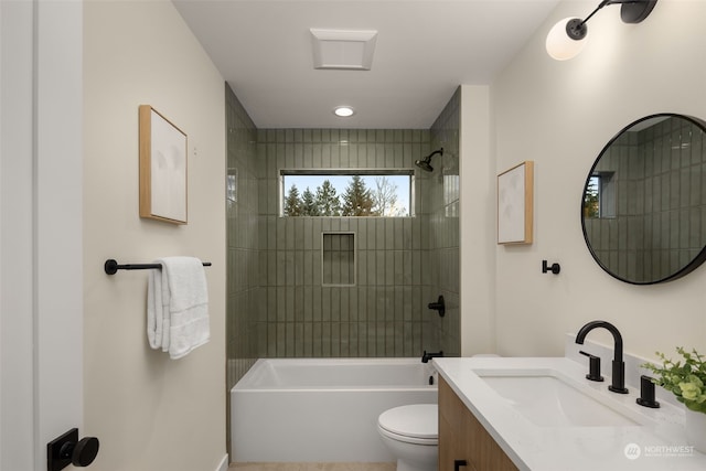 full bathroom featuring vanity, toilet, and tiled shower / bath