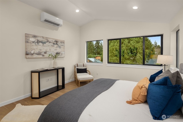 bedroom featuring vaulted ceiling, light hardwood / wood-style floors, and an AC wall unit