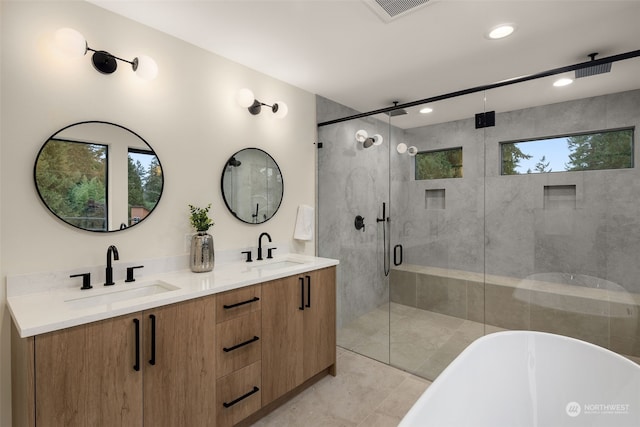 bathroom with tile patterned flooring, shower with separate bathtub, vanity, and a healthy amount of sunlight