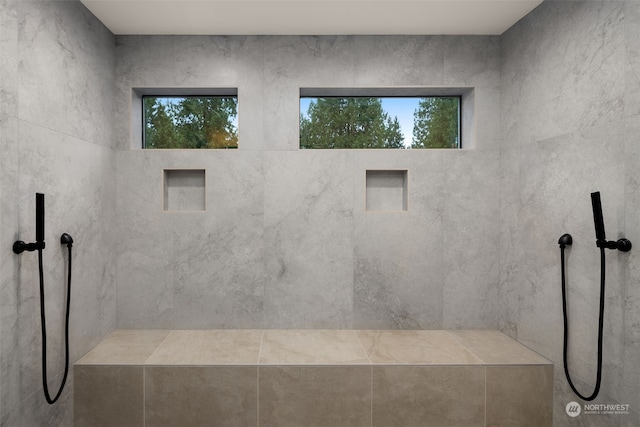 bathroom featuring a tile shower