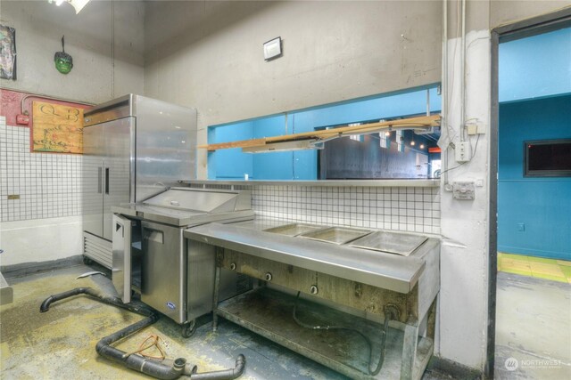 kitchen featuring high end fridge