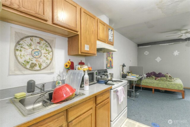 kitchen featuring white electric range oven, ceiling fan, sink, and light carpet