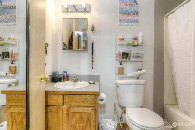 bathroom featuring vanity and toilet