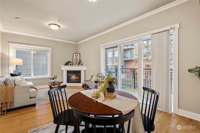 dining room featuring crown molding and light hardwood / wood-style flooring