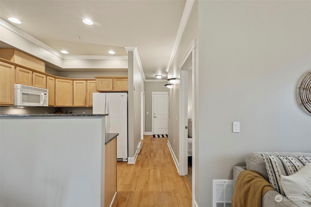 kitchen featuring light hardwood / wood-style flooring, dark stone countertops, crown molding, white appliances, and light brown cabinetry