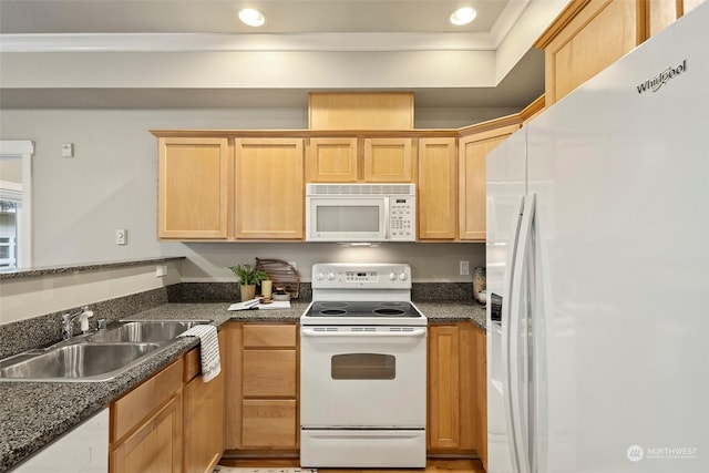 kitchen featuring light brown cabinets, dark stone countertops, white appliances, and sink