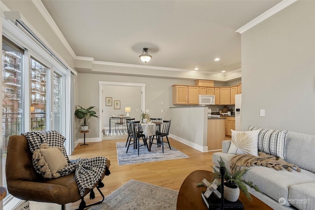 living room featuring light wood-type flooring and ornamental molding