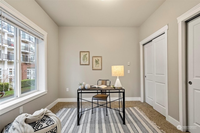 office area featuring light carpet