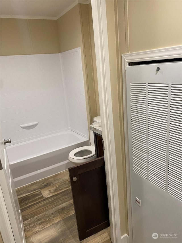 bathroom with hardwood / wood-style floors, vanity, and ornamental molding