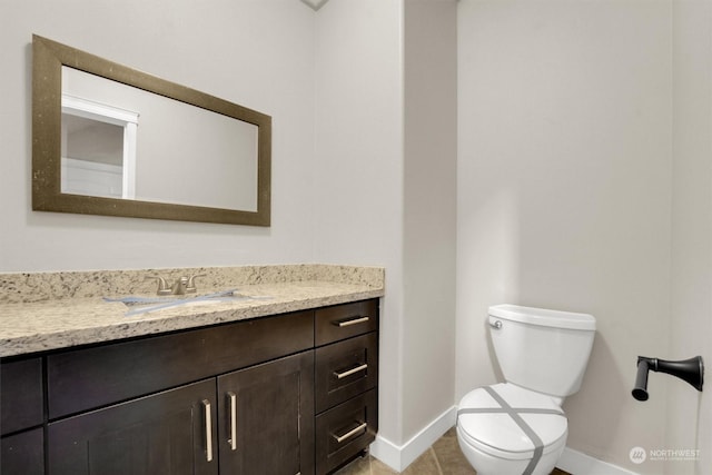 bathroom with tile patterned floors, vanity, and toilet