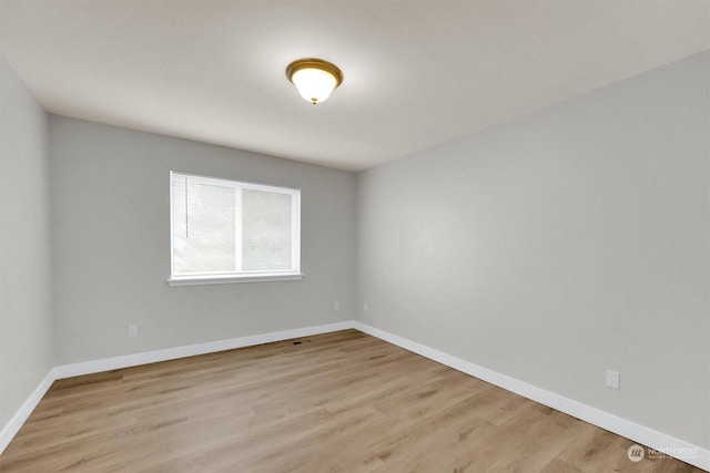 spare room with light wood-type flooring