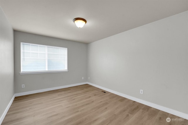 unfurnished room with light hardwood / wood-style flooring