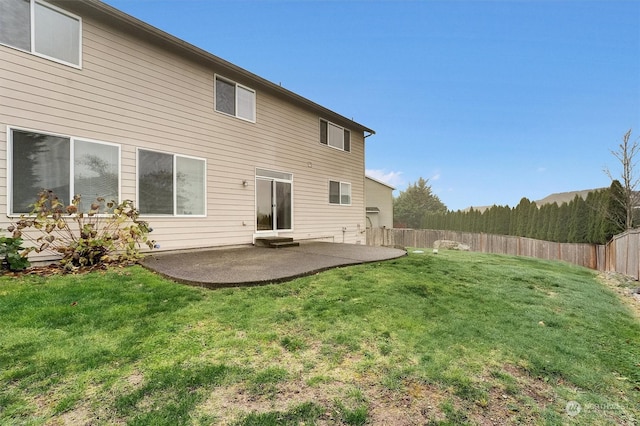 back of property with a patio and a lawn