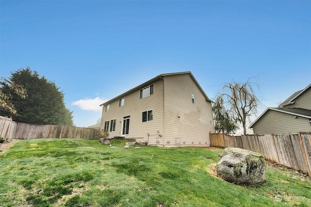 rear view of property featuring a yard