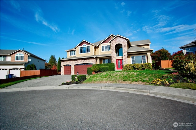 view of front of house featuring a front lawn and a garage