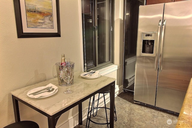 kitchen featuring stainless steel refrigerator with ice dispenser