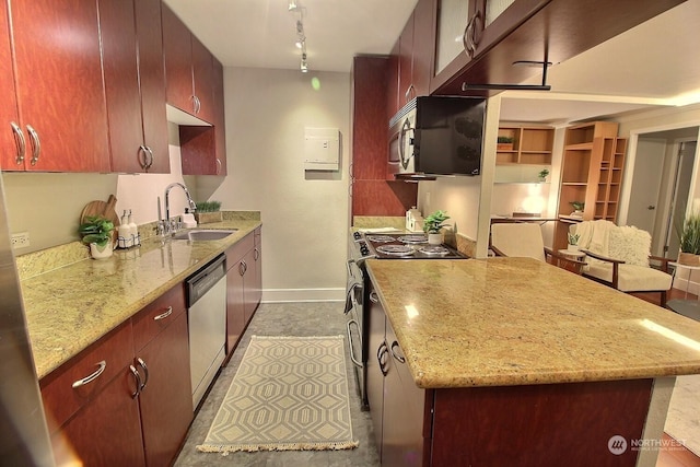 kitchen featuring light stone counters, sink, and stainless steel appliances