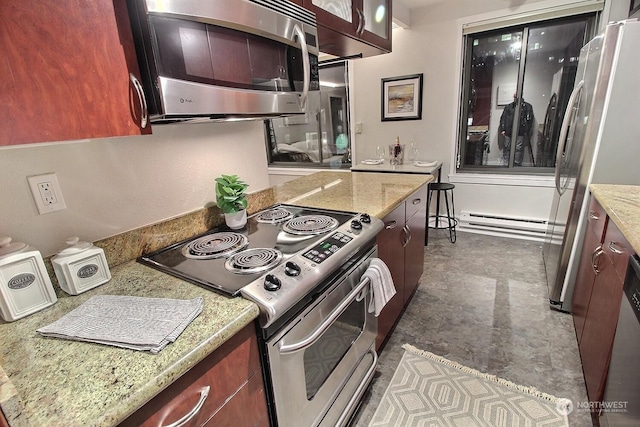 kitchen featuring light stone counters, stainless steel appliances, and a baseboard radiator