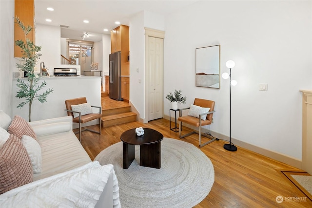 living room featuring sink and light hardwood / wood-style floors